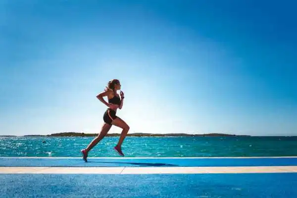 Woman running showing strong leg muscle Harwich